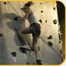 girl climbing rock wall